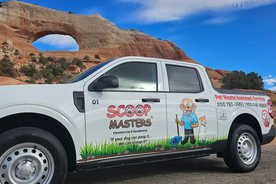 image of Scoop Masters pet waste removal service truck in front of arches national park